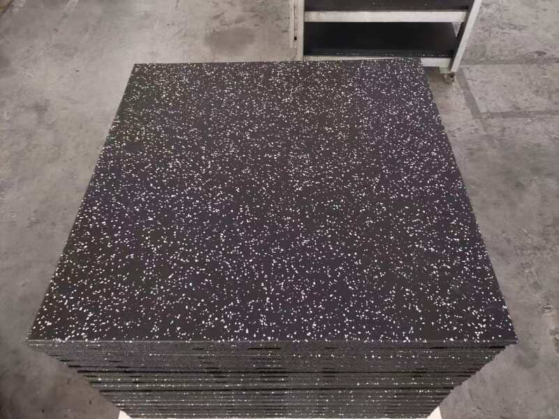 alt text: A clipboard with a checklist on top of a sample of artificial turf and rubber flooring